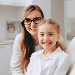 Girl and her mother smiling on couch together