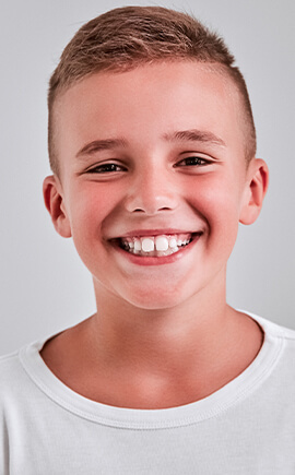 Smiling young boy in white tee shirt