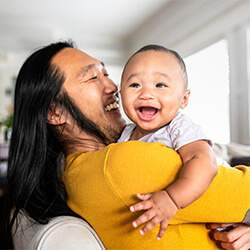 Father holding his laughing baby