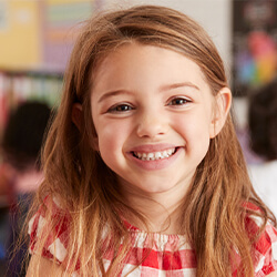 Young girl with long brown hair smiling