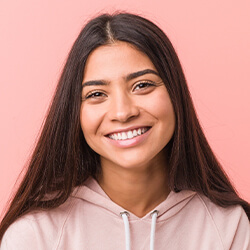 Teenage girl in pink jacket smiling